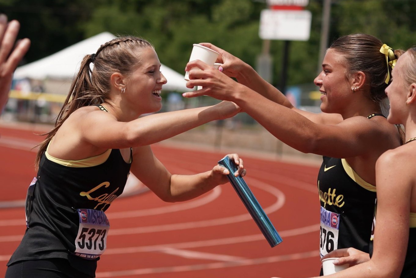 Kelly with track and field team at State championship