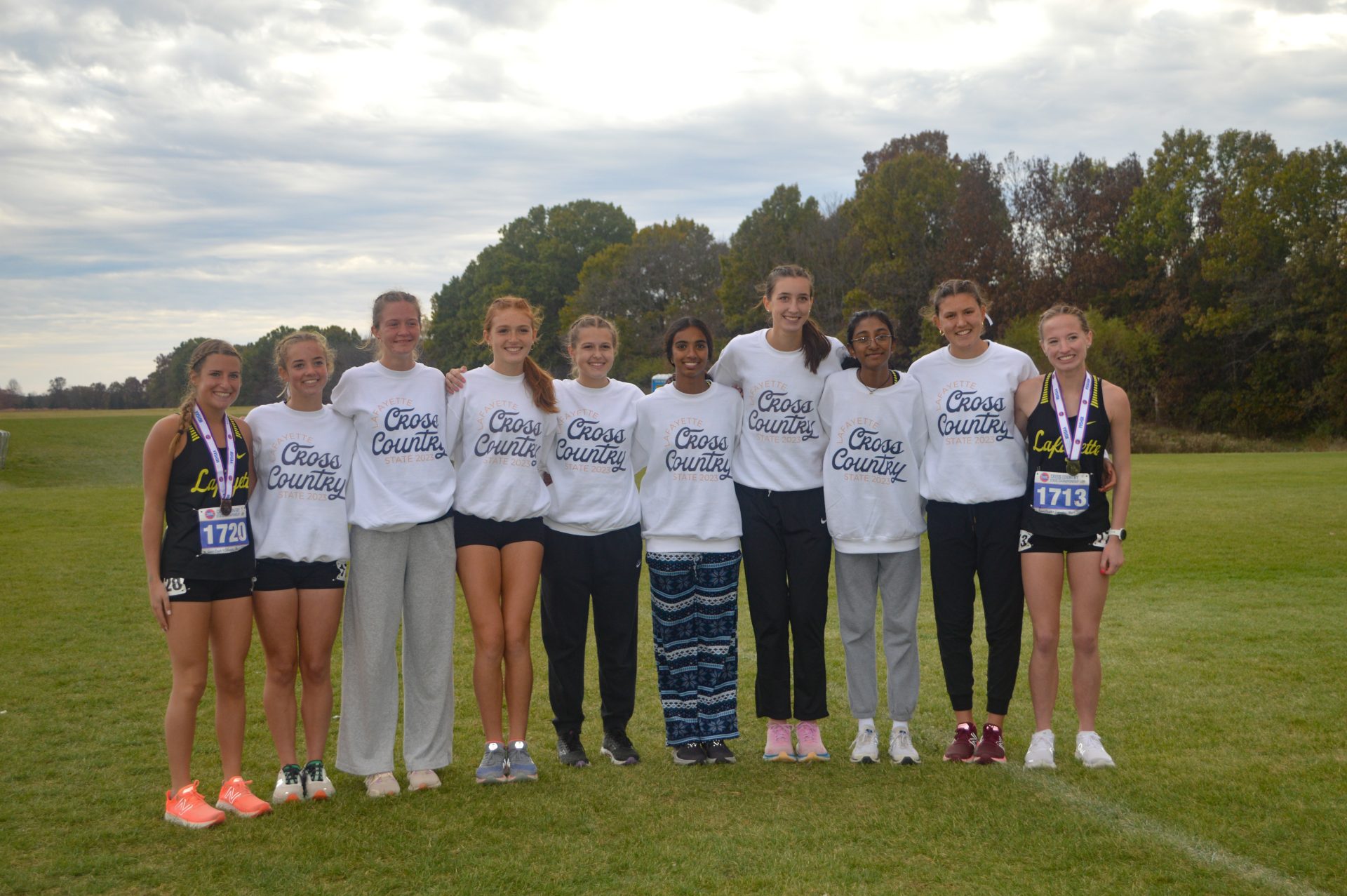 Kelly with cross country team at 2023 State