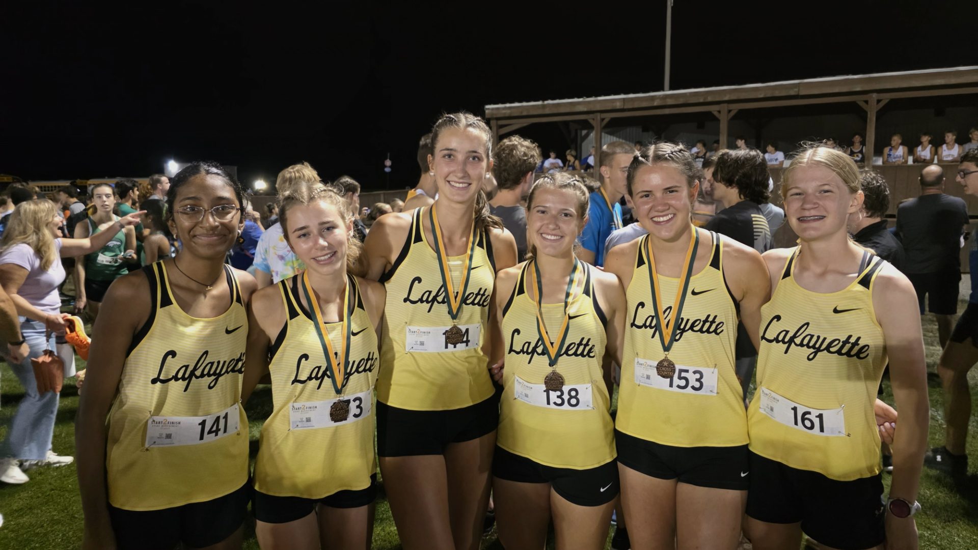 Kelly with cross country team at 2025 FZ Twilight