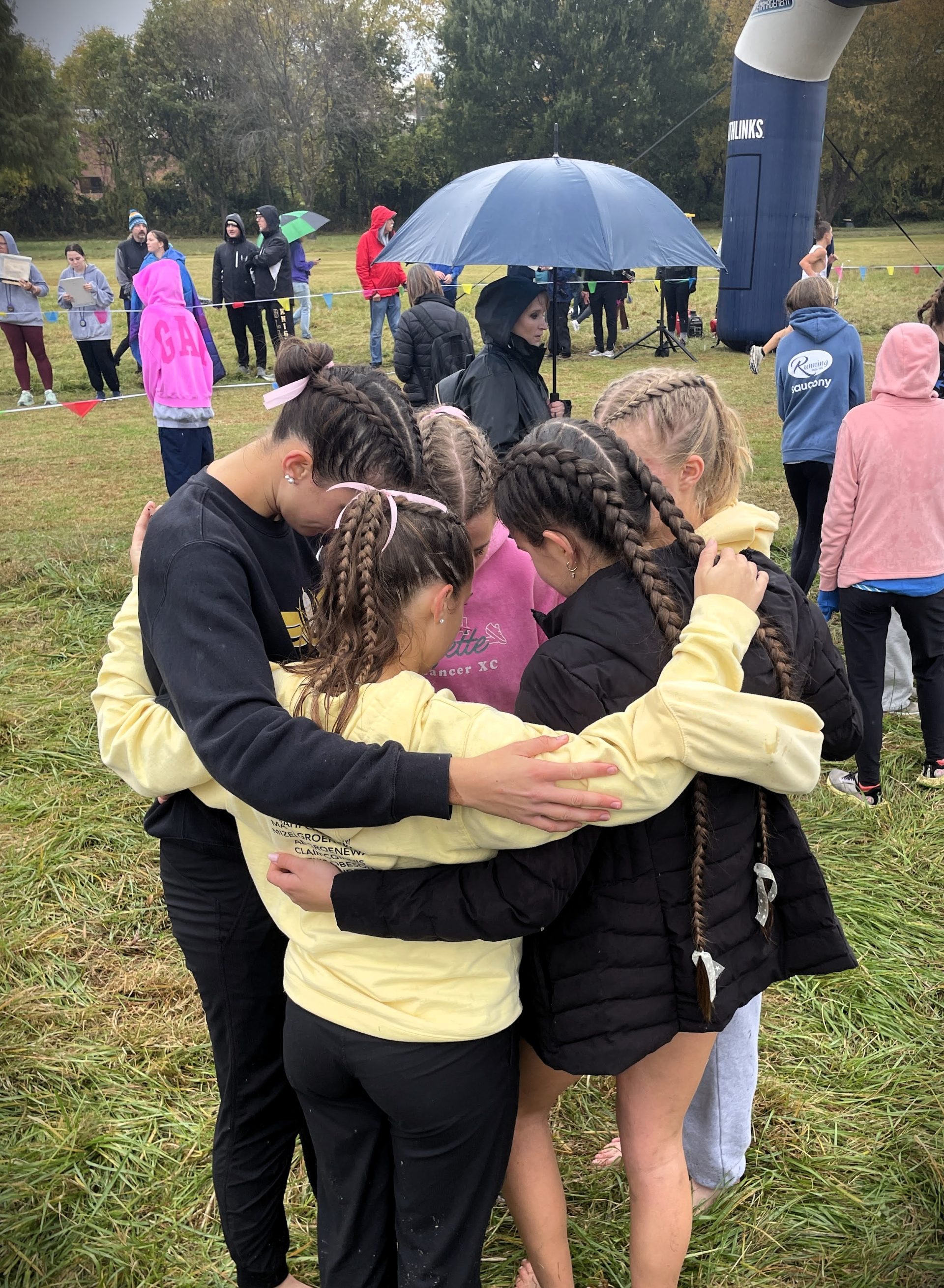 Kelly with cross country team at 2025 State
